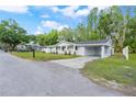 Inviting single-story home with a side carport and manicured lawn at 16411 Lake Byrd Dr, Tampa, FL 33618
