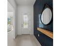 Inviting entryway with tile floors, a stylish mirror and access to the bedroom at 17093 Moonflower Dr, Venice, FL 34293