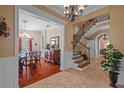 Elegant foyer with hardwood floors and a grand staircase showcases the home's exquisite design at 1915 Floresta View Dr, Tampa, FL 33618