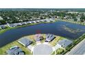 Aerial view of a home situated on a waterfront lot in a quiet neighborhood at 2563 Ocean Breeze Ln, Clearwater, FL 33761