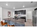 Modern kitchen featuring granite countertops, stainless steel appliances, and a breakfast bar at 32775 Brooks Hawk Ln, Wesley Chapel, FL 33543