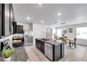 Contemporary kitchen with an island, stainless steel appliances, and an adjacent dining area at 32775 Brooks Hawk Ln, Wesley Chapel, FL 33543