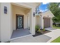 Stylish front entrance with modern lighting fixtures and a unique glass-paneled door at 3803 E Curtis St, Tampa, FL 33610