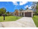 Lovely home with a well-kept lawn, driveway, and an attached one-car garage at 3803 E Curtis St, Tampa, FL 33610