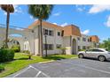 Exterior view of condo complex showcasing maintained grounds and unique architectural details at 381 S Mcmullen Booth Rd # 72, Clearwater, FL 33759