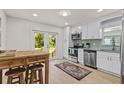 Bright, renovated kitchen with stainless steel appliances, white cabinets, and access to the backyard at 3906 N Ola Ave, Tampa, FL 33603