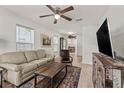 Cozy living area filled with natural light, neutral-toned furniture, and wood-look flooring at 3906 N Ola Ave, Tampa, FL 33603