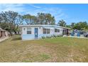 Delightful single-story home with blue trim, decorative yard art, and a cozy, welcoming appeal at 4707 Alma St, New Port Richey, FL 34652