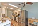 Bright kitchen with stainless steel appliances, butcher block countertops, and ceiling fan at 4997 Bostonian Loop # 4997, New Port Richey, FL 34655