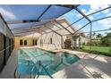 Inviting screened-in pool area with a view of the private backyard, perfect for relaxation and outdoor entertaining at 5290 White Sand Ne Cir, St Petersburg, FL 33703