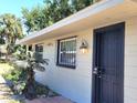 A bright single-story home with secure doors, window bars, and manicured landscaping at 5401 E 14Th Ave, Tampa, FL 33619