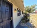 Close-up of the front entrance of a cozy single-story home showing secure doors and wall lighting at 5401 E 14Th Ave, Tampa, FL 33619