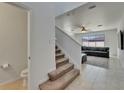 Inviting entryway leads to a spacious living room with tile flooring and a comfortable sectional sofa at 5942 Sweet Birch Dr, Riverview, FL 33578