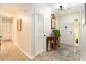 Inviting foyer with tiled floor, mirror, console table and decorative rug at 626 Marphil Loop, Brandon, FL 33511