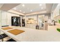 Spacious kitchen with white cabinets, granite countertops and view of the laundry room at 626 Marphil Loop, Brandon, FL 33511