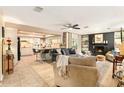 Open-concept living room flows into a modern kitchen, featuring a fireplace and ample seating at 626 Marphil Loop, Brandon, FL 33511