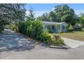 A cozy single-story home with a vibrant garden and a welcoming front porch at 6709 N 13Th St, Tampa, FL 33604
