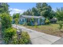 Inviting single-story home featuring a quaint front porch and well-maintained landscaping at 6709 N 13Th St, Tampa, FL 33604