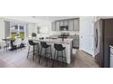 Modern kitchen with granite countertops, stainless steel appliances, a center island, and bar stool seating at 6955 Broad River Ave, Land O Lakes, FL 34638