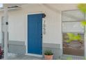 Stylish front door with modern house number and a charming, welcoming entrance at 7050 Jenner Ave, New Port Richey, FL 34655