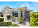Charming home exterior featuring manicured landscaping, a cozy front porch, and large windows at 7061 Lamium Ct, Brooksville, FL 34602