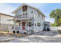 Charming two-story home with a front porch and second story balcony, plus a red front door at 757 32Nd N Ave, St Petersburg, FL 33704