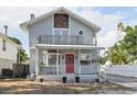 Charming two-story home with a front porch and second story balcony, plus a red front door at 757 32Nd N Ave, St Petersburg, FL 33704