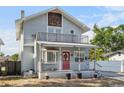Charming two-story home with a front porch and second story balcony, plus a red front door at 757 32Nd N Ave, St Petersburg, FL 33704