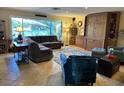 Spacious living room with tile floors, comfortable seating, and a large window that provides ample natural light at 836 Magellan Dr, Sarasota, FL 34243