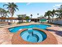 Inviting backyard oasis with a sparkling blue pool and mature landscaping at 1025 Boca Ciega Isle Dr, St Pete Beach, FL 33706