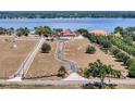 Sprawling estate featuring a large home, expansive grounds, and serene waterfront views at 11715 Taylor Rd, Thonotosassa, FL 33592