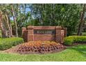 Community entrance sign for Radcliffe, framed by manicured greenery and colorful flowerbeds at 11910 Keating Dr, Tampa, FL 33626