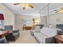Inviting living room featuring a neutral color palette, plush seating, and a large mirrored wall at 12400 Park Blvd # 522, Seminole, FL 33772