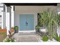 Stylish light blue double doors, enhanced by elegant landscaping, welcome you to this beautiful home at 1502 Creekbend Dr, Brandon, FL 33510