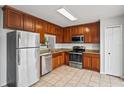 Well-equipped kitchen with stainless steel appliances, granite countertops, and ample cabinetry at 1506 Lenton Rose Ct, Trinity, FL 34655