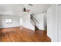 Spacious living room with hardwood floors, a ceiling fan, and staircase access to the next level at 1506 Lenton Rose Ct, Trinity, FL 34655