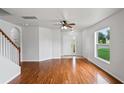 Bright living room with hardwood floors and plenty of natural light from the large windows at 1506 Lenton Rose Ct, Trinity, FL 34655