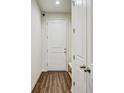 Entryway featuring hardwood floors and white trim offering a clean and modern look at 1510 Blue Sea St, Clearwater, FL 33756