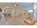 Open-concept living room with updated flooring, ceiling fans, and ample natural light at 1511 Meridel Ave, Tampa, FL 33612