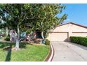Inviting single-story home with a two-car garage and manicured landscaping at 1823 Atrium Dr, Sun City Center, FL 33573