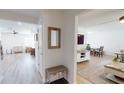 Bright hallway featuring wood-look floors, neutral walls, and an open view to the dining and living room at 1849 Del Robles Dr, Clearwater, FL 33764