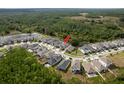 Aerial view showcases the home's location within a well-planned community, surrounded by lush greenery and other residences at 21590 Violet Periwinkle Dr, Land O Lakes, FL 34637