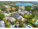 Stunning aerial view of single-Gathering home with pool and lush landscaping, nestled in a picturesque neighborhood at 219 Miramar Ne Blvd, St Petersburg, FL 33704