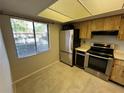 Bright kitchen featuring stainless steel appliances, tile floors, and a large window for natural light at 229 Mary Dr # 229, Oldsmar, FL 34677