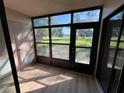 Enclosed lanai offering scenic views of the outdoors and featuring durable flooring and ample natural light at 229 Mary Dr # 229, Oldsmar, FL 34677