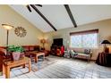 Comfortable living room with vaulted ceiling, beams, and ample seating at 2600 Forest Run Ct, Clearwater, FL 33761