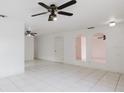 Spacious living room with tile flooring, ceiling fans, and arched openings at 3213 W Ivy St, Tampa, FL 33607