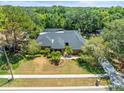 Inviting single-story brick home with a screened-in pool, mature trees, and manicured landscaping at 3309 Westmoreland Dr, Tampa, FL 33618