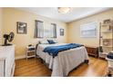 A cozy bedroom featuring wood floors, two windows, a comfortable bed and neutral decor at 4160 30Th N St, St Petersburg, FL 33714