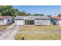 A charming single-story home with a well-manicured front lawn, garage and inviting porch at 4160 30Th N St, St Petersburg, FL 33714